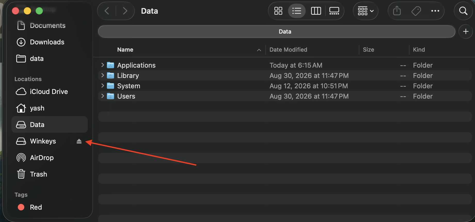 Finder sidebar with the eject arrow next to the Winkeys disk
